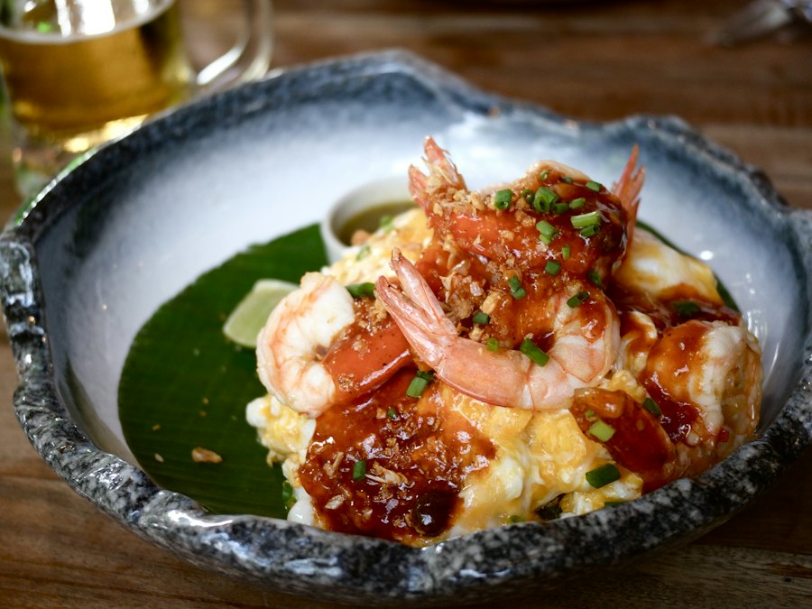 Shrimp and grits served in a decorative bowl