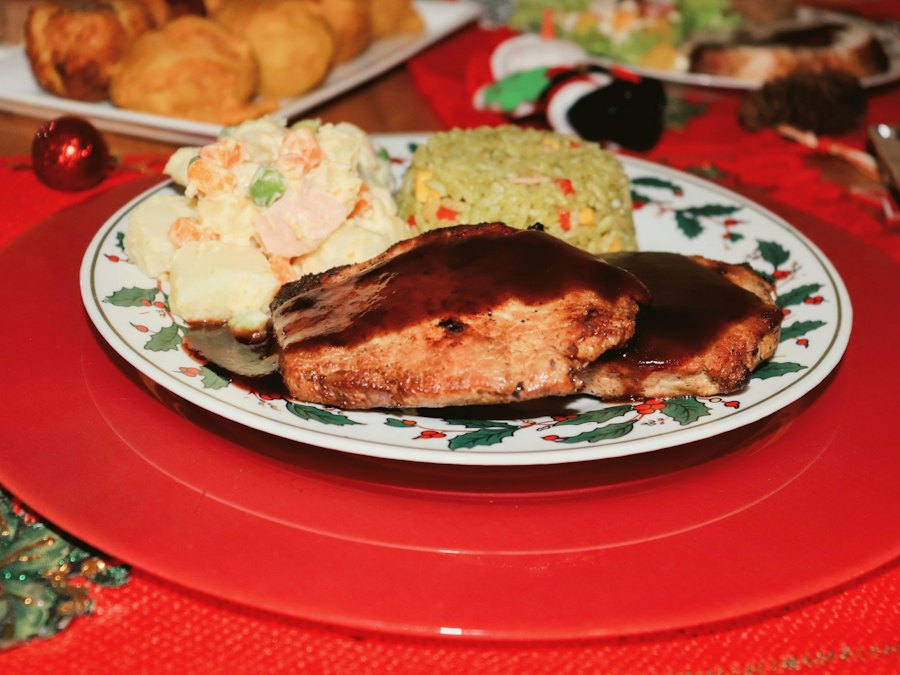 Two glazed pork chops plated with rice and salad