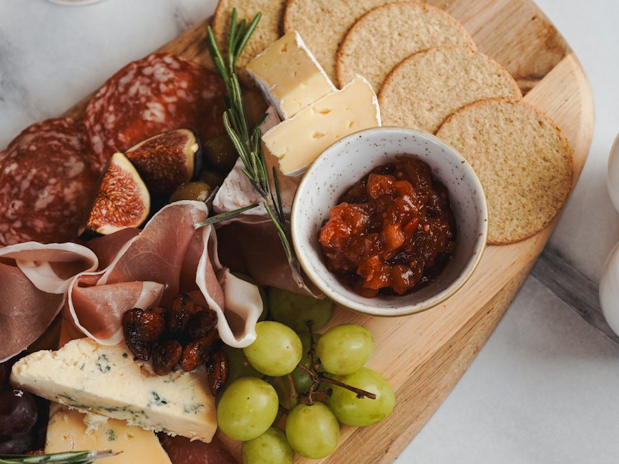 Charcuterie board with cured meats, cheeses, fruit and crackers